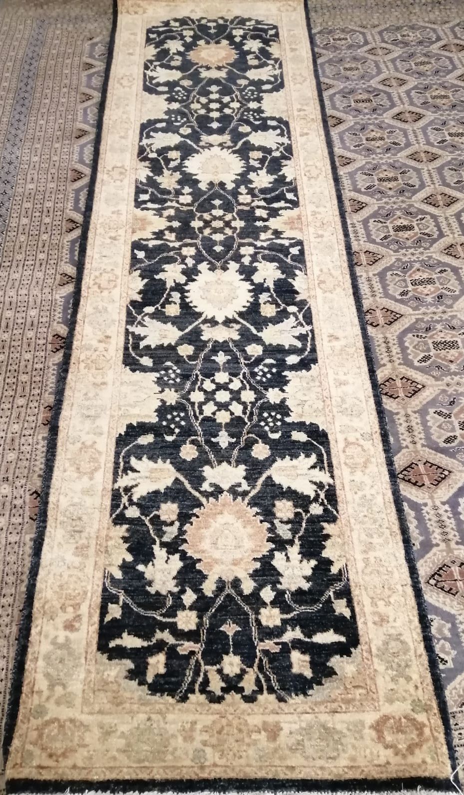 A Ziegler dark blue ground runner with stylised floral motifs, 300 x 82cm